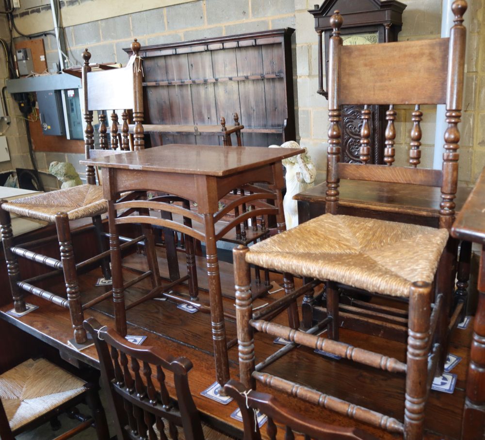 A pair of spindleback rush seat chairs and an Arts and Crafts side table, table W.57cm